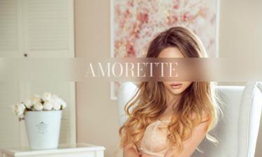 Elite Escortmodel Julie from krakow with dark blonde hair sitting on a chair in white lingerie with high heels.